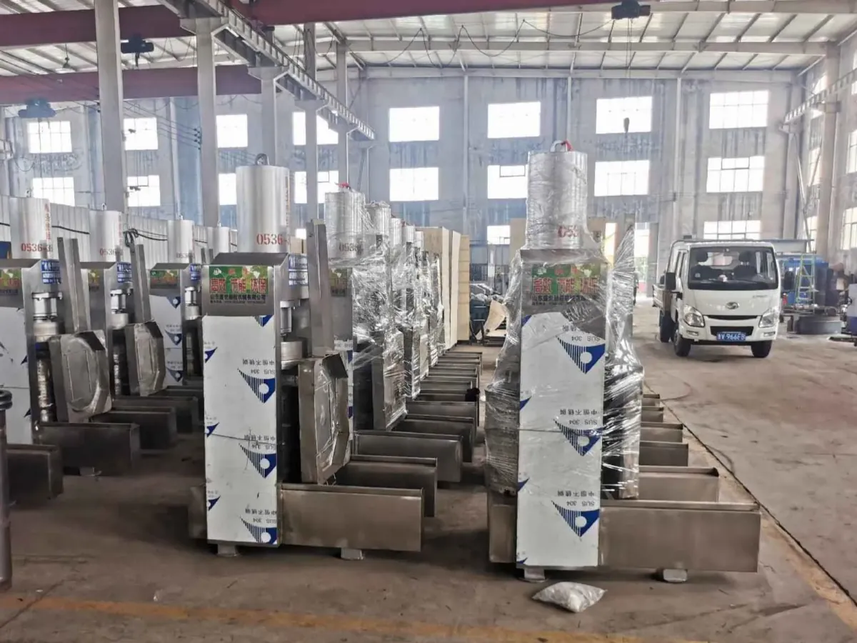 Packaged stainless presses lined up for loading with a truck behind