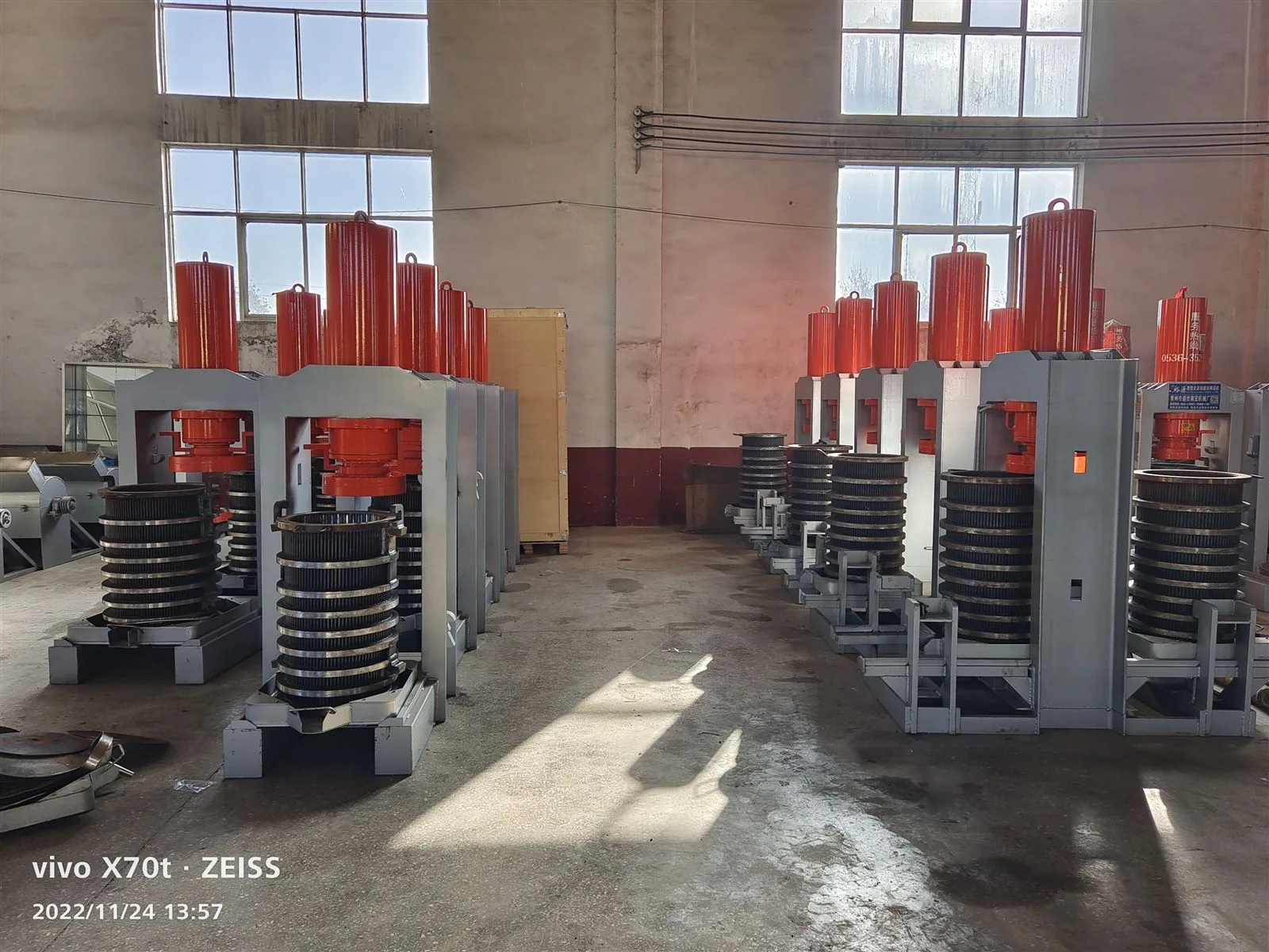 Two rows of hydraulic presses facing each other on the production floor